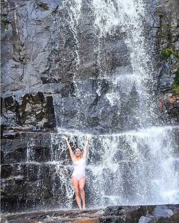 Water flowing over the layered rocks of Karera Waterfalls
